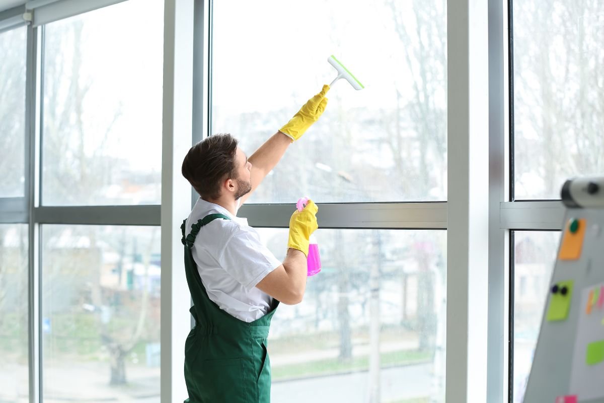 overalls uses a squeegee to clean windows, showcasing his dedication to maintaining a clear view.